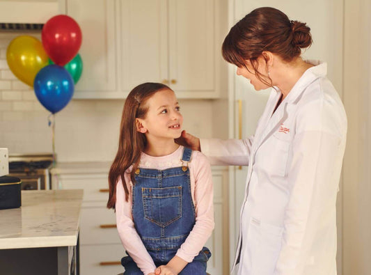 Rowan-nurse-at-home-doing-professional-ear-piercing-with-young-girl
